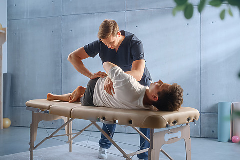 A physiotherapist can help with stretching the muscles and spine